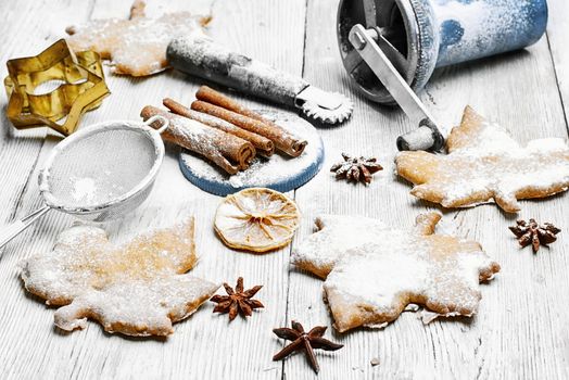 Homemade cookies in the shape of maple leaf on the kitchen table, for the winter holidays