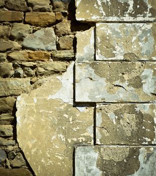 background battered old corner stone walls of the house