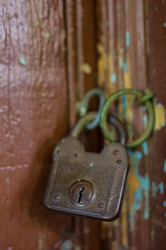 Old rusty lock on the wooden gate