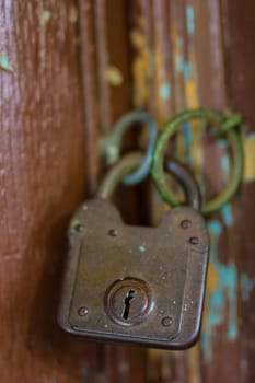 Old rusty lock on the wooden gate