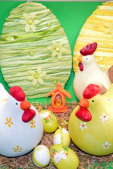 Three hens of Easter with eggs on the straw.