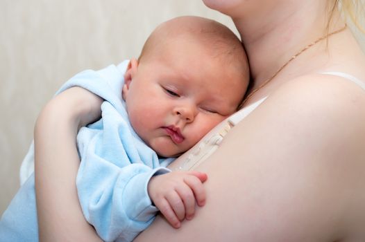 Baby falls asleep on hands at mother close up shot