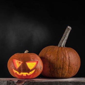 Funny glowing Halloween pumpkins on a black background