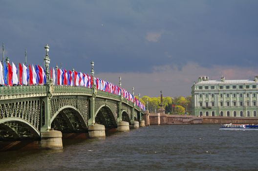 SAINT PETERSBURG, RUSSIA - MAY10, 2014: the Bascule Trinity Bridge Troitsky bridge across the Neva river with tricolor flags