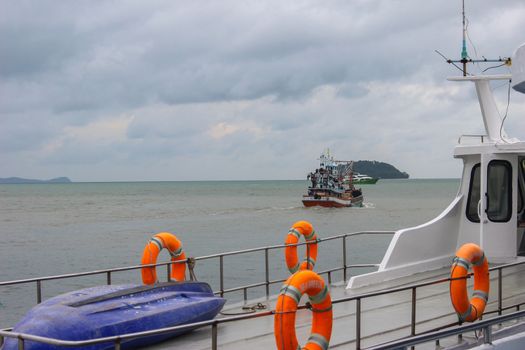 lot Ring life boys on big boat. Obligatory ship equipment. Personal flotation device. Prevent drowning. Orange lifesaver on the deck of a cruise ship. Traveling to an island