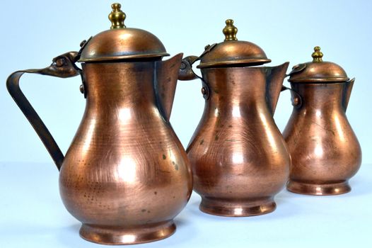 Three copper jars of several size.