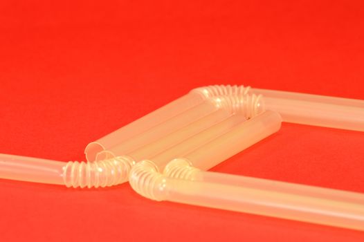 Plastic pipe with corner in the shape of spring on red bottom