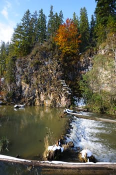 Small rapids at Lacul Rosu, the Red Lake or Killer Lake, Eastern Carpathians, Transylvania, Romania at autumn