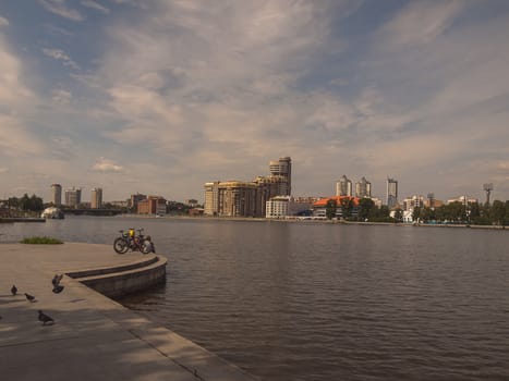 Embankment of the river Iset. Yekaterinburg city. Summer.  Day. Cloudy. City landscape. Sverdlovsk region. Russia.