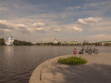 Embankment of the river Iset. Yekaterinburg city.  Summer.  Day. Cloudy. City landscape. Sverdlovsk region. Russia.