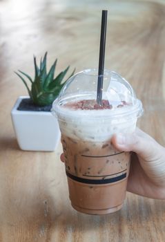 Iced coffee with green plant background, stock photo