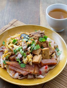 china noodle mixed with egg, sausage, pork, mushroom and tofu