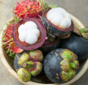 mangosteen and rambutan on wood table