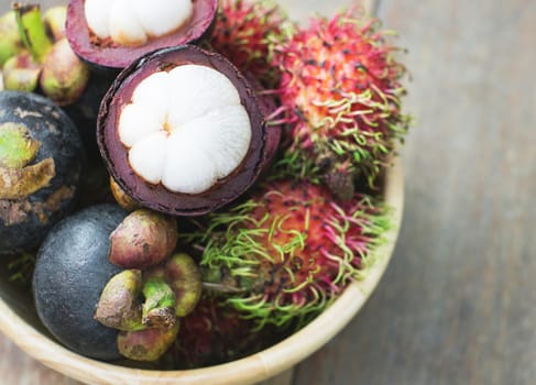 mangosteen and rambutan on wood table