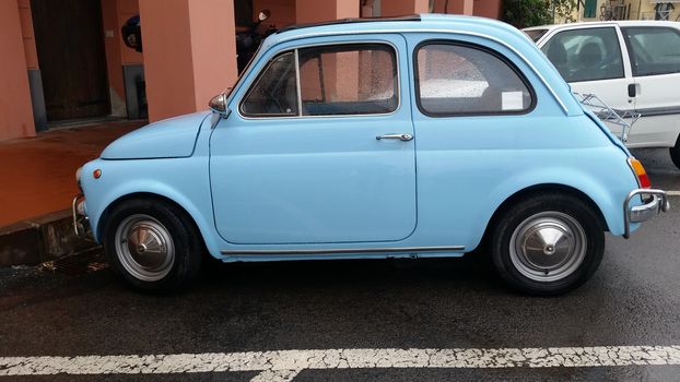 Ventimiglia, Italy - October 23, 2016: Small Italian Car Fiat 500 Parked on the Street of Ventimiglia. Blue Fiat 500 L