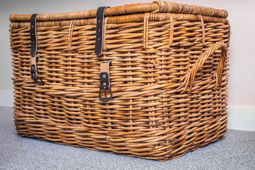 Wicker basket on the light background in the room