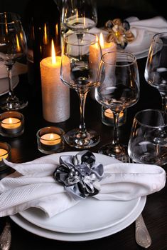 Fragment of table setting for dinner by candlelight