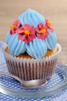 Muffin decorated with a delicate cream closeup