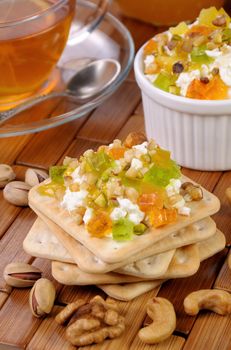 portion of cottage cheese with jam and marmalade, nuts on a cracker