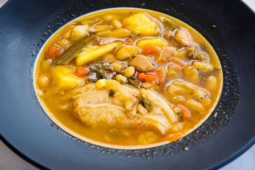 traditional spanish lentil soup with chorizo and vegetables.