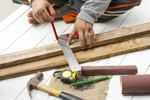 Male carpenter working with wood pencil and  tools at work place.Background craftsman tool.Zoom in11