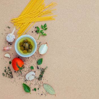 Italian food concept pasta with vegetables olive oil flavored with spices herb rosemary ,thyme,parsley and champignon mushroom set up with brown background.