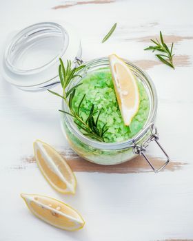 Aromatic sea salt with aromatic herbs . Fresh peppermint ,sage and rosemary. Nature spa ingredients and body scrub. Herbal remedies. Flat lay on white wooden table.