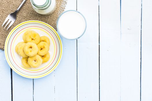 Donut dessert and milk bottle and milk glass  on wooden sky blue table.Meal or breakfast hi-vitamin and calcium.14