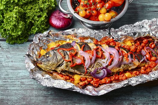 Mackerel baked in tomatoes and spices on the kitchen table