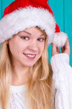 Beautiful woman in Christmas cap. blue background