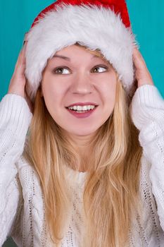 Beautiful woman in Christmas cap. blue background