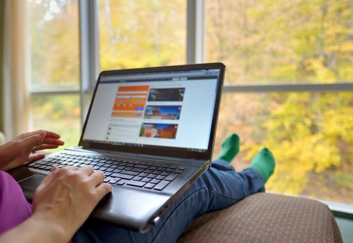 Woman working with laptop  in hotel room