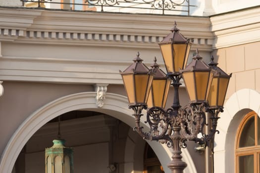 old fashioned street lamp on yellow building background