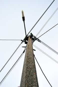 Electric pole with cables and street lighting