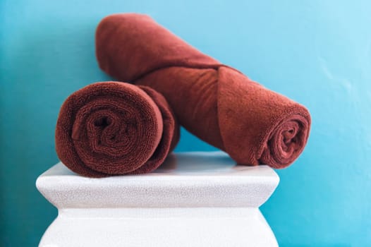 brown towels on white chair in room