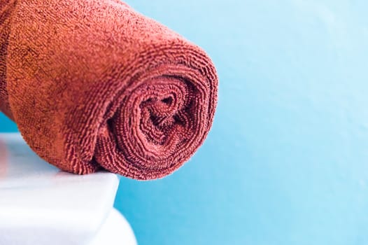 brown towels on white chair in room