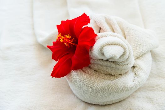 white towel with a flower on white background