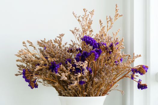 dried purple flower in vase