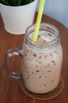 Iced coffee with green plant background, stock photo