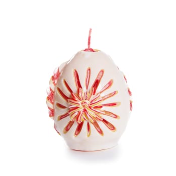 Carved colored candle isolated on white background