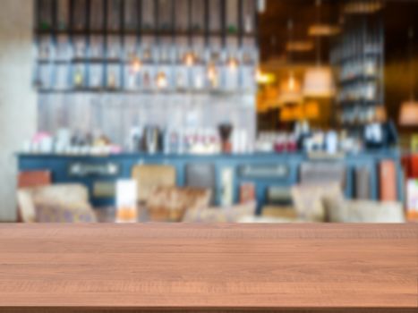 Dark wooden board empty table in front of blurred background. Perspective brown wood over blur in cafe interior - can be used for display or montage our products. Mockup your products