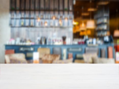 White wooden board empty table in front of blurred background. Perspective whitewood over blur in cafe interior - can be used for display or montage your products. Mockup your products