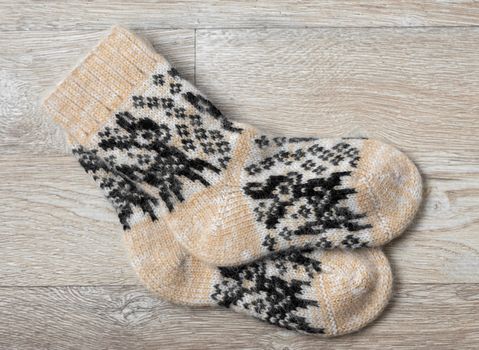 Pair of wool socks against wood background