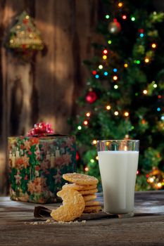 close up view of glass of milk with cookies on color back