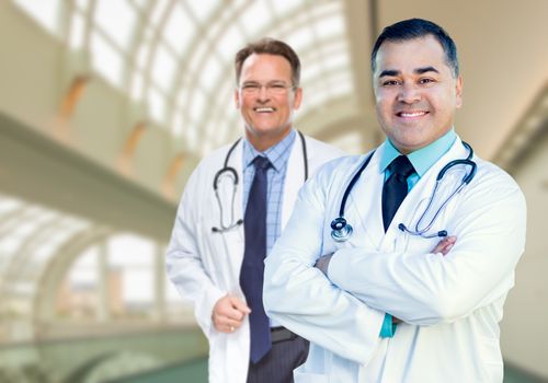 Handsome Male Doctors or Nurses Standing Inside Hospital Building.