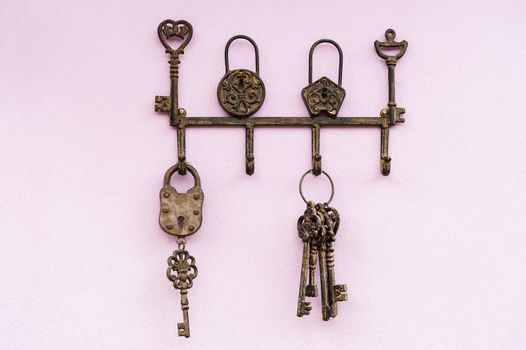 brass antique skeleton keys hanging on pink wall