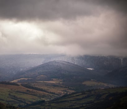 Overcast scene in cloudy mountains. November rain