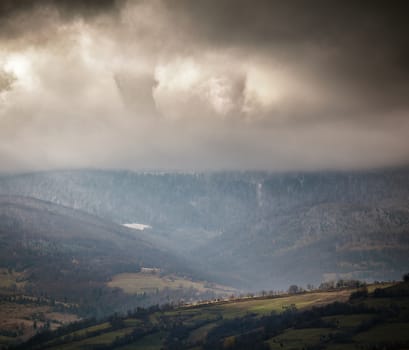 Overcast scene in cloudy mountains. November rain