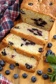Summer pie  blueberry with sliced berries on a blackboard