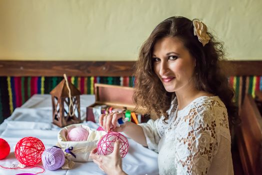 Girl doing decoration with balloons and colored threads